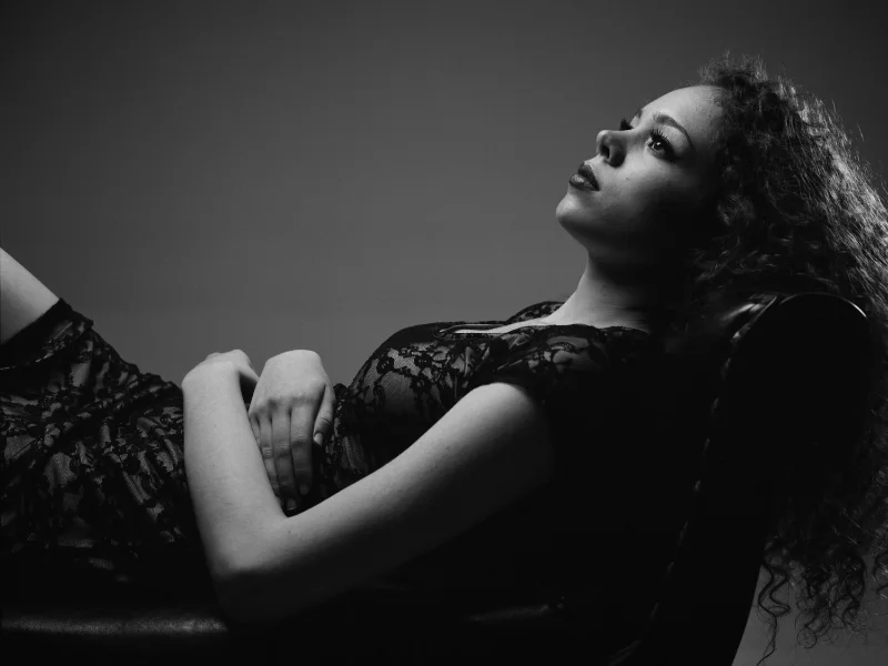 2 light setup. Softbox placed above model, aimed straight down. No fill light. Hair light placed behind model, camera right. Ilford Pan F Plus.