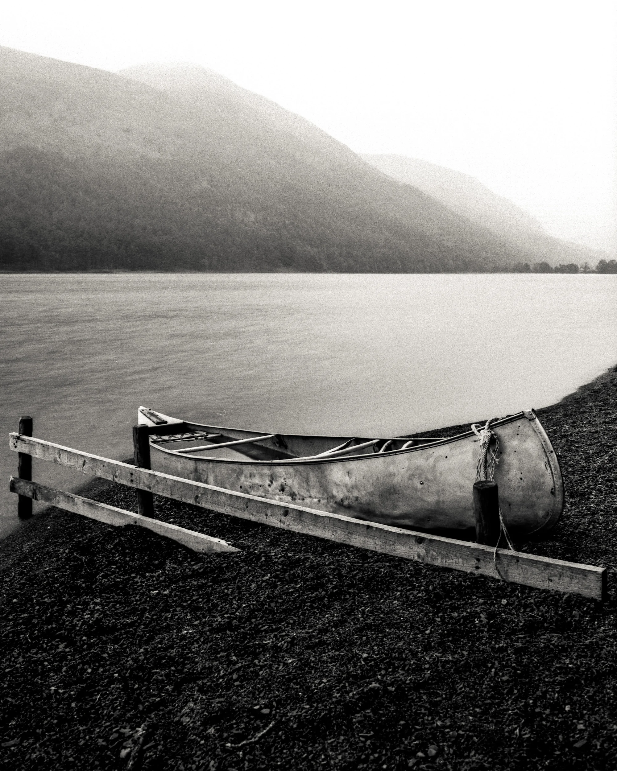Mamiya 645 Pro TL, 45mm, Delta 100. Finding a silver boat with a wooden fence next to it on a dark rock beach is just a tone perfect subject for black and white. The boat set against the mountain with a combination of rain and sun in the background for me creates a quite dynamic image with a very static subject.