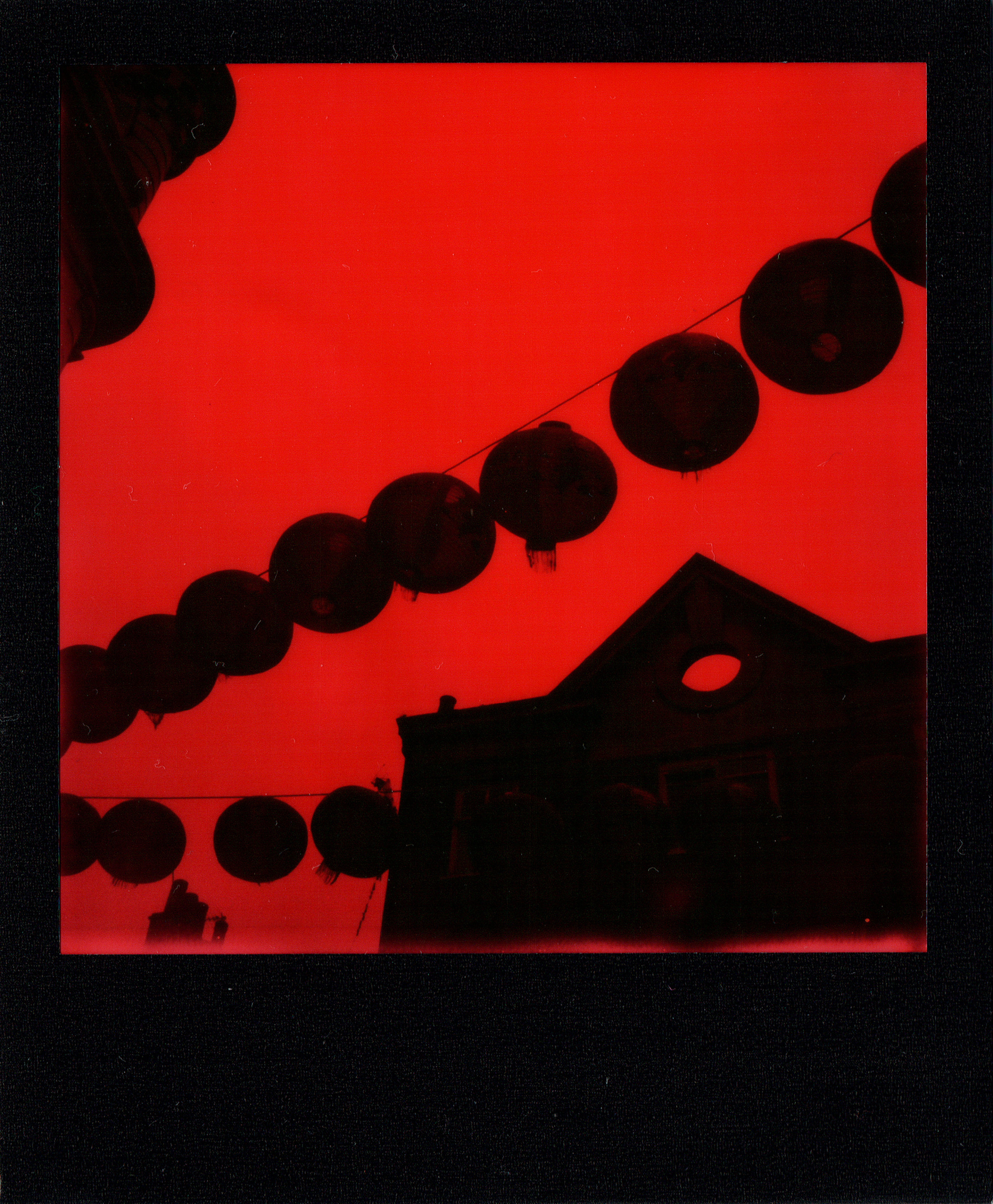 Enigma In China Town | Polaroid SLR680 | Impossible Project Black & Red Duochrome | Claudio Gomboli 