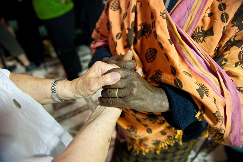 Grandmothers Holding Hands - Photo by Peter Bregg