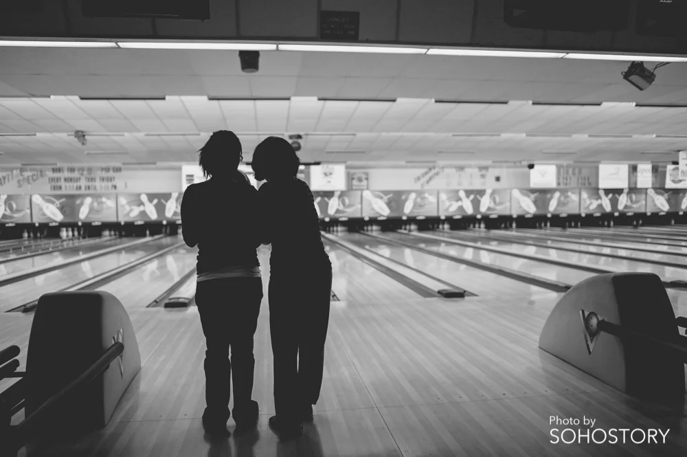 My mom teaching my wife how to bowl
