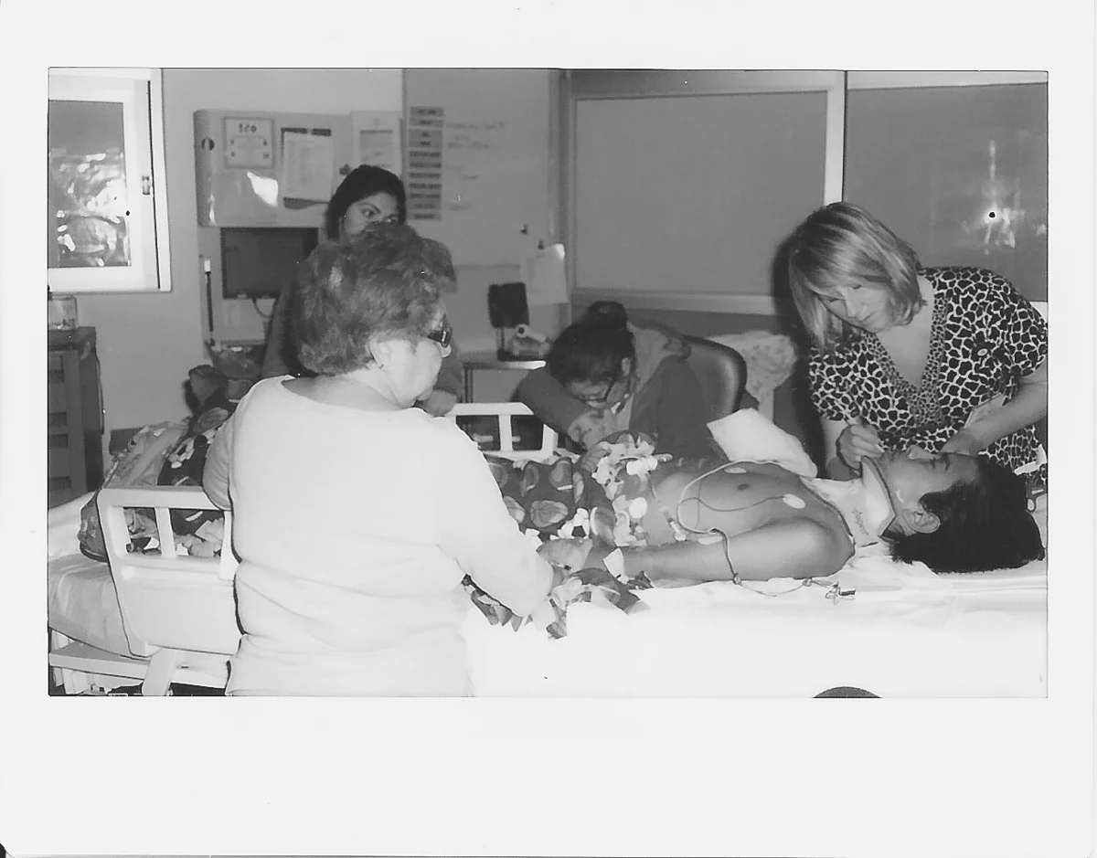 The nurse cares for Rolff and his tireless mother rests for just a minute.