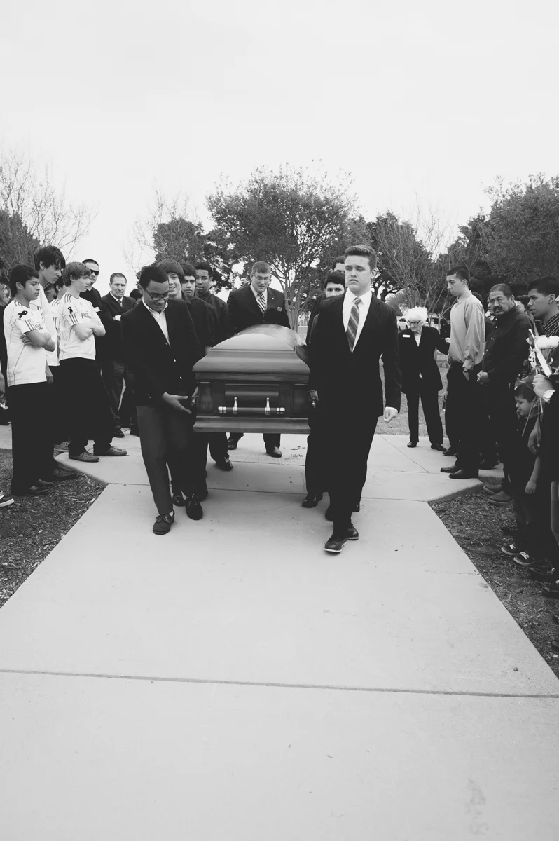 Rolff's friends carrying the casket.