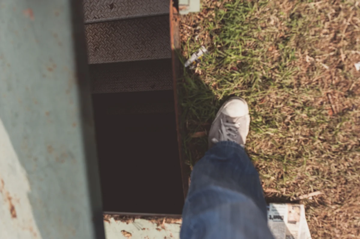 The narrow stairs leading down to the storm shelter.