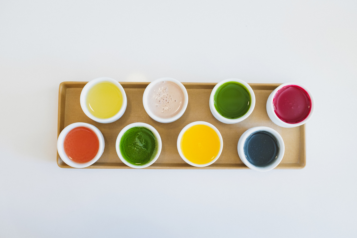 The bright colors of the juices, filled to the brim in sake glasses, look like little wells of paint.