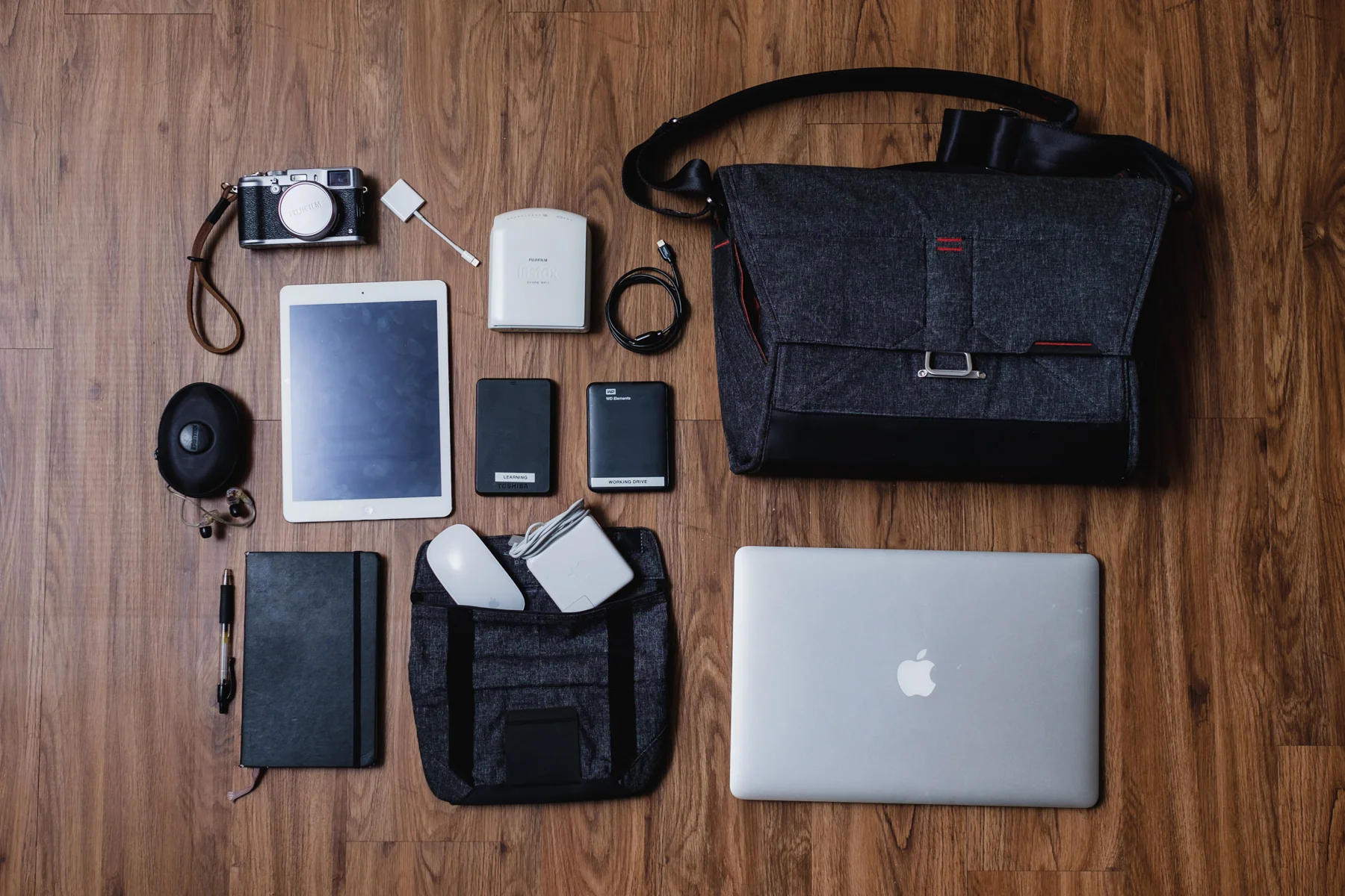 This is my other everyday setup (heavy version) 'Gotta get creative bag' - Fujifilm X100s camera, Apple iPad Air, Apple Lighting to SD Card Adapter, Shure E535 Earphones, Moleskine notebook with Pilot G-2 Pen, Fujifilm Instax Printer SP-1, Apple Magic Mouse, Apple MagSafe Charger, and Apple Macbook Pro 15 "