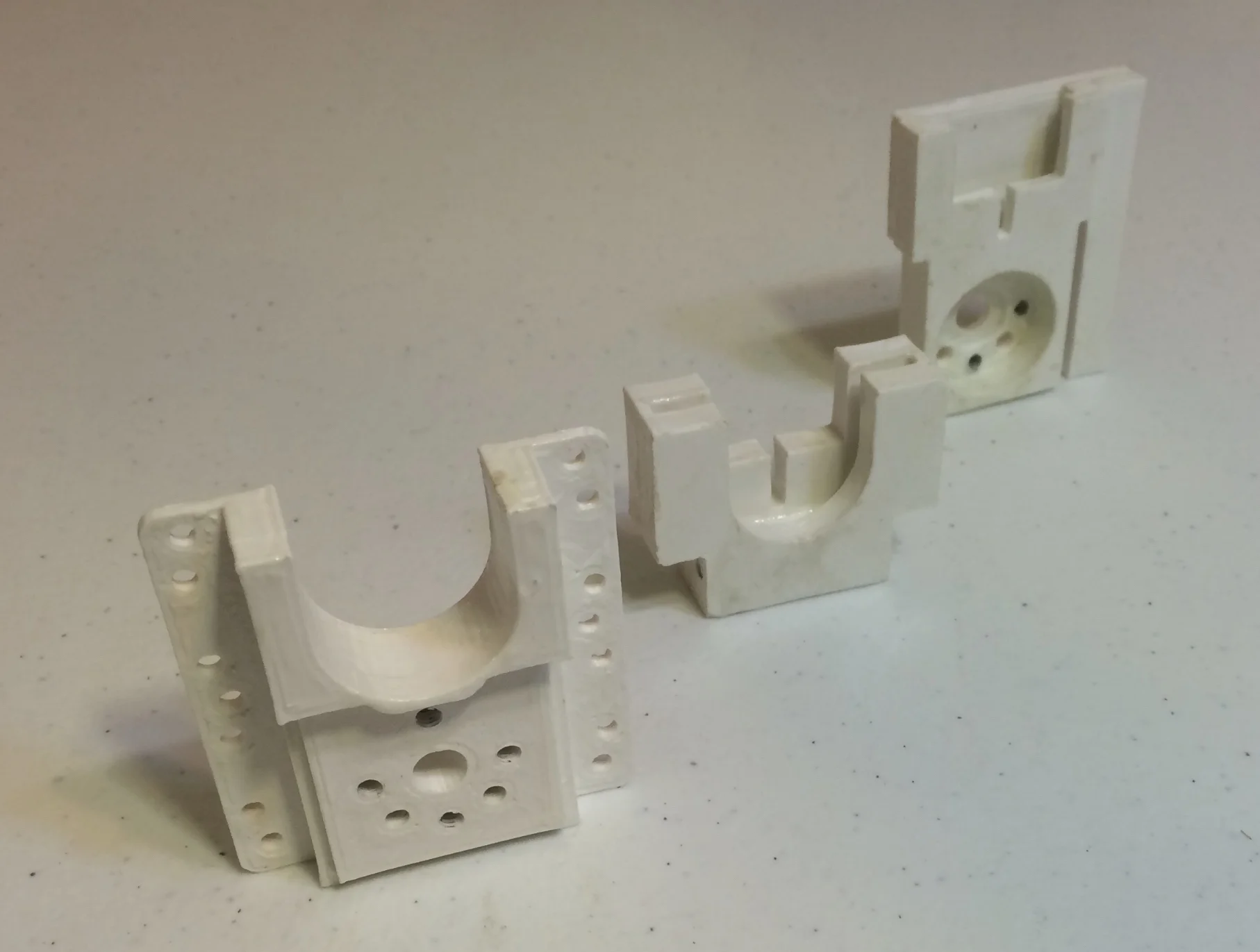 Assembled 3d Printed parts. From left to right: the front mount, mid mount, and plunger unit.
