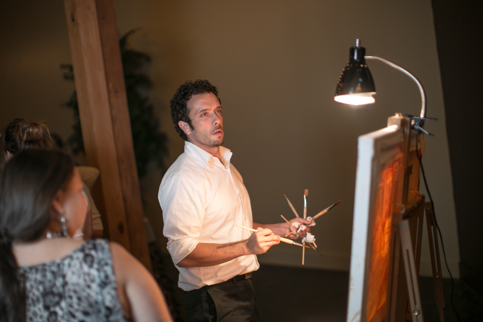 Artist Ben Keys is surrounded by guests as he paints live at a faux wedding reception hosted at The Mill Event Hall in Chattanooga, Tennessee // Photo Courtesy of Imago Photography