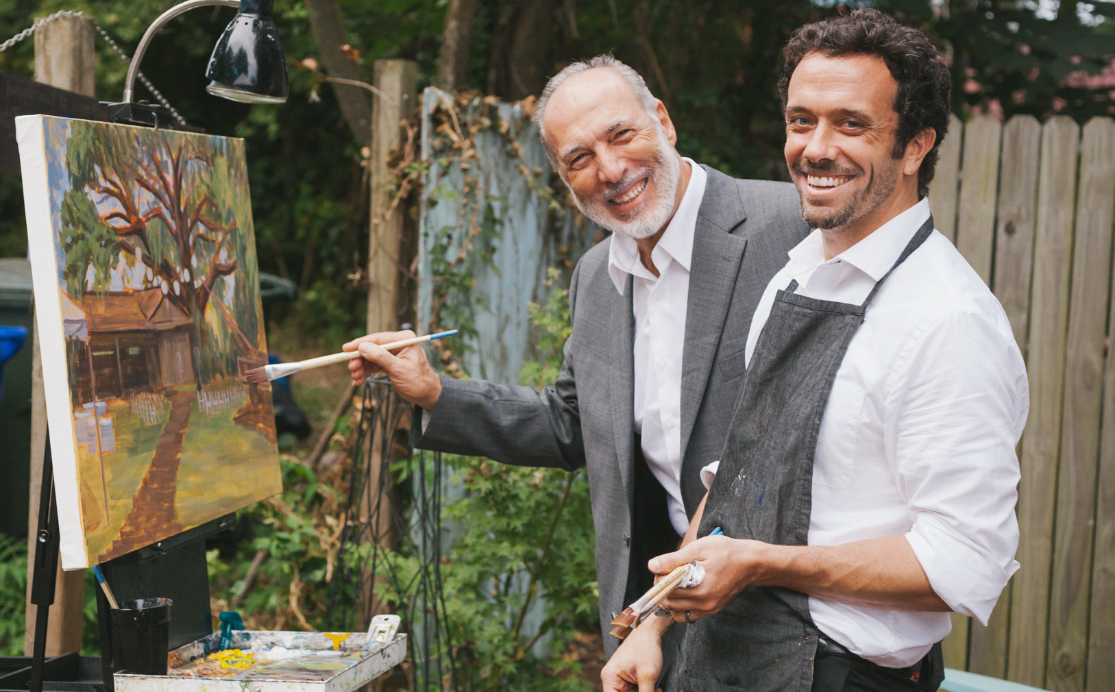 Vikki's dad adds his own artistic touch to the wedding painting.  Photo courtesy of Adam Chandler Photography