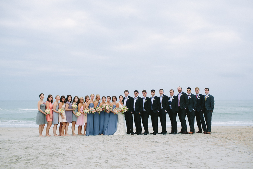 wedding-party-on-the-beach-mulit-colored-bridesmaids-dresses-each-wearing-different-color