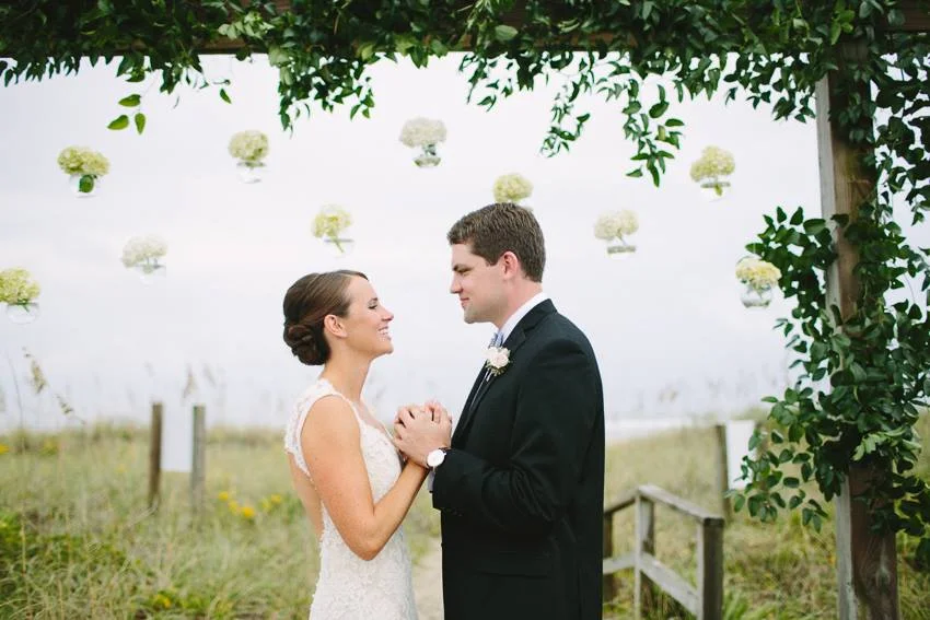 hanging-flowers-on-the-beach-bride-and-groom-wed-on-canvas