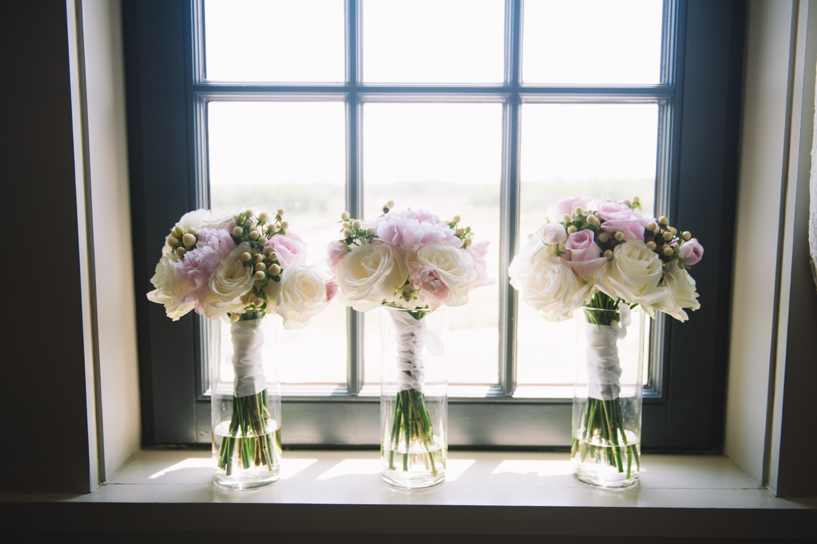 bridesmaids-bouquets-in-a-window-on-wedding-day
