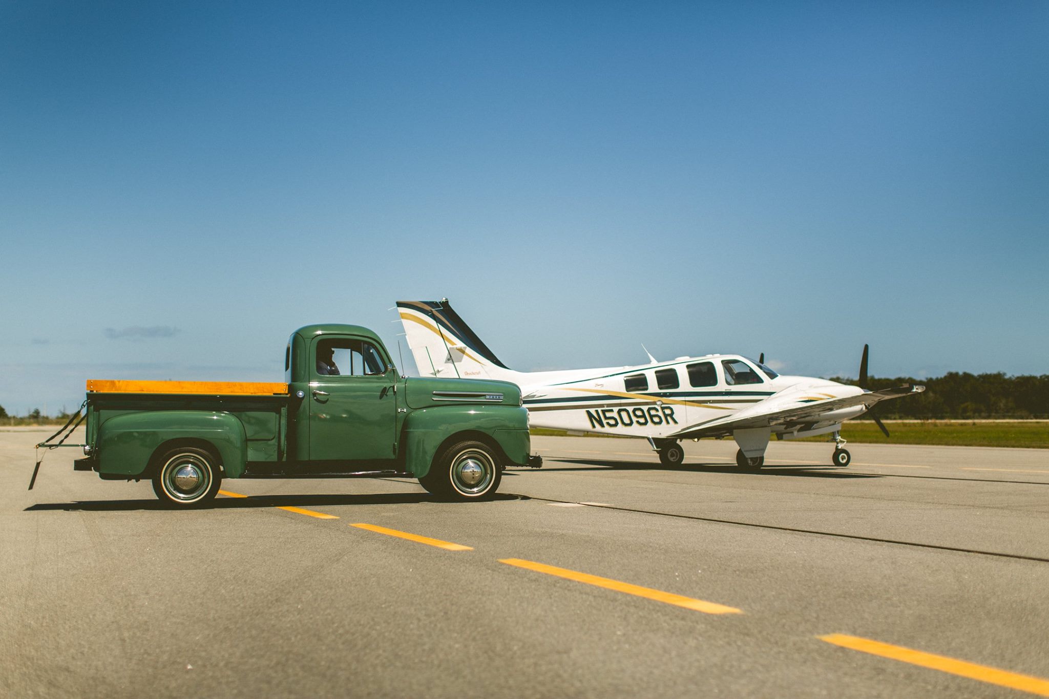 bride-and-groom-exit-by-vintage-truck-airplane