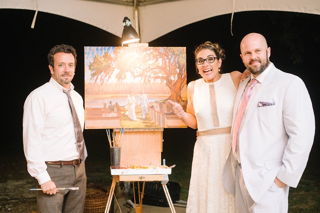 Thanks so much to Aaron + Jillian Photography for capturing this photo of the sweet bride and groom with their live wedding painting!