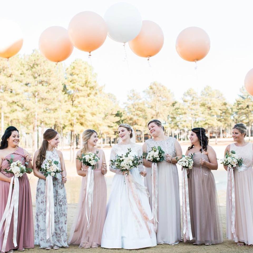 bridal-party-with-huge-balloons-and-champagne-dresses