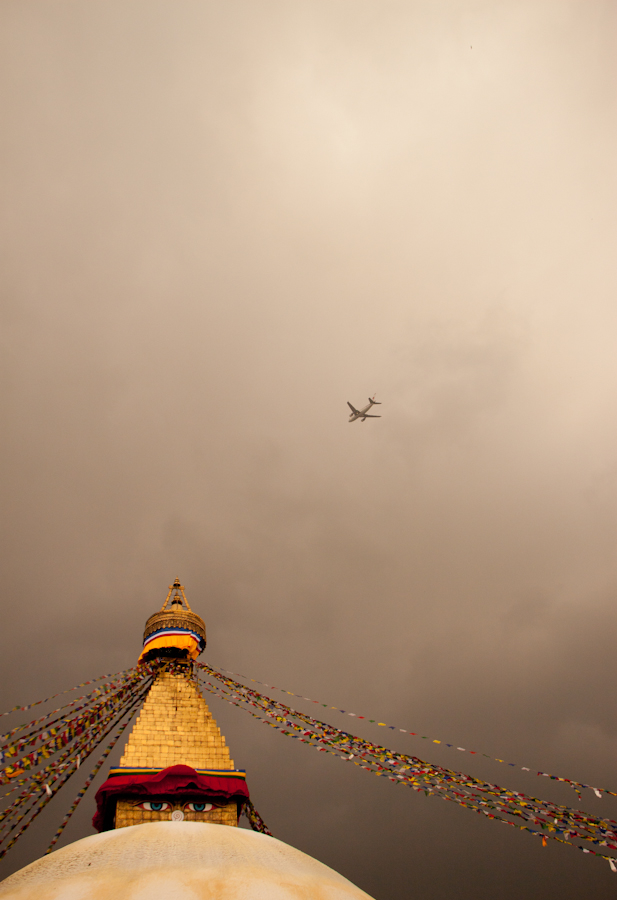 An airplane flies over Boudhanath Stupa in Kathmandu, Nepal.jpg