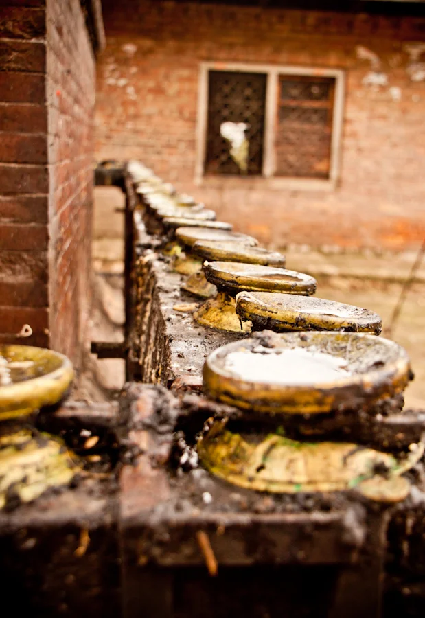 prayer lamps are filled with rain water in Bhaktapur, Nepal.jpg