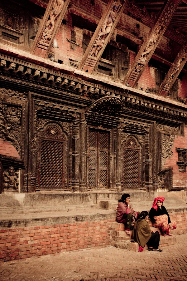 some Nepalese women sit outside one of the temples near Durbar Square in Bhaktapur, Nepal.jpg