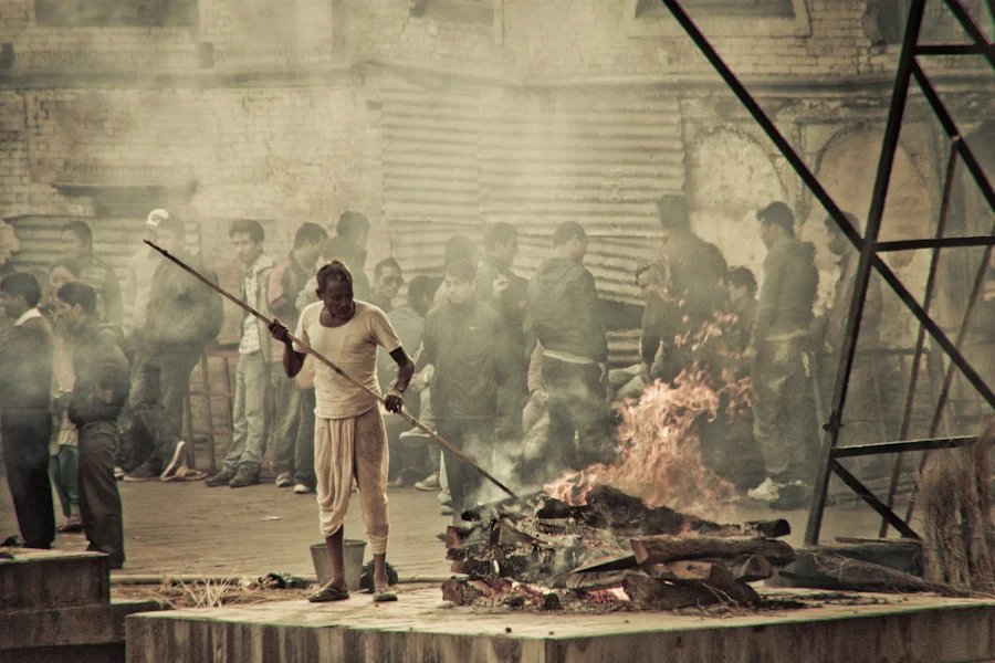 An open-air cremation taking place in Pashupatinath temple near Bagmati River in Kathmandu Nepal.jpg