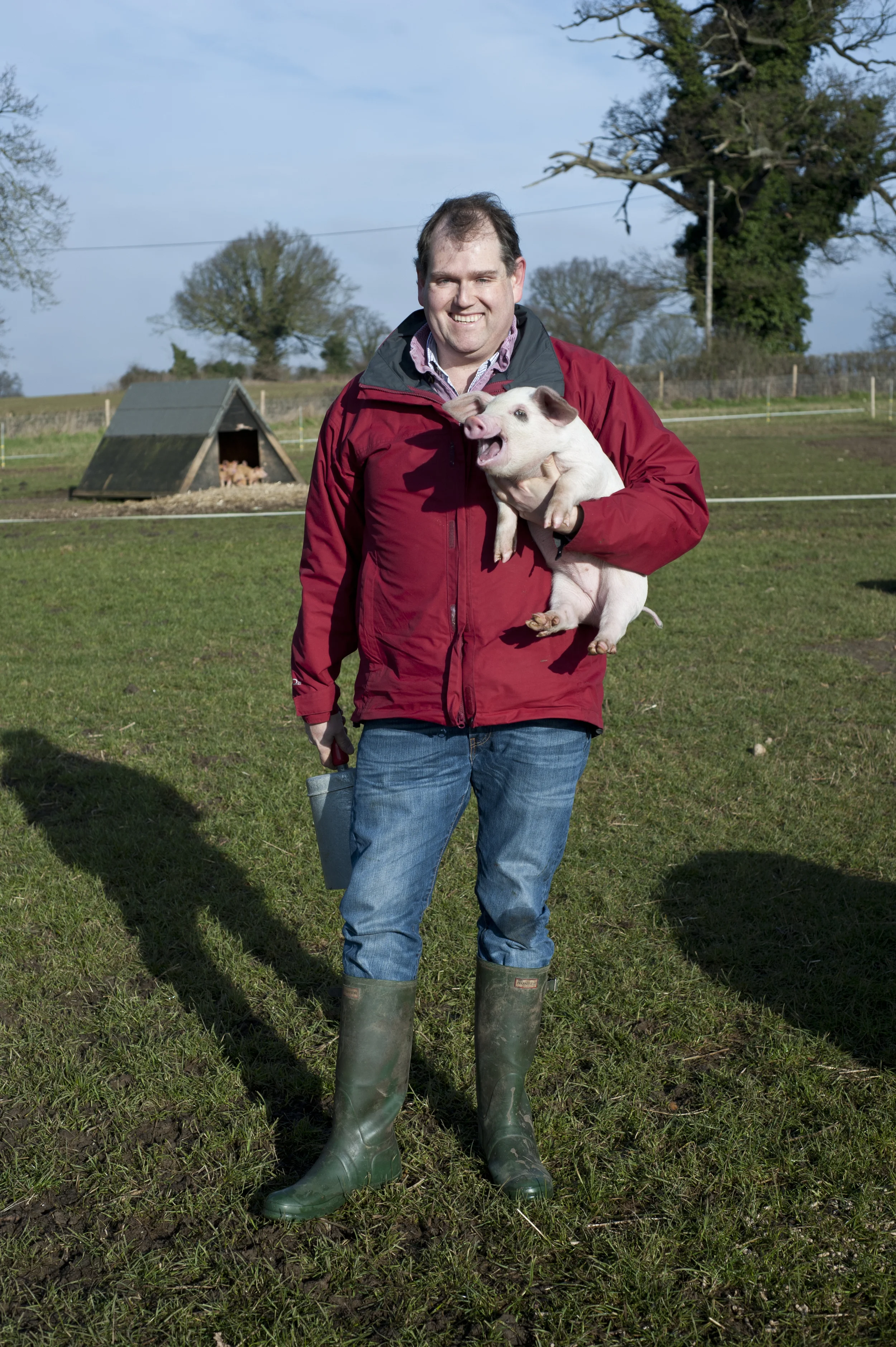 Adrian Melrose with a young free-range piglet.