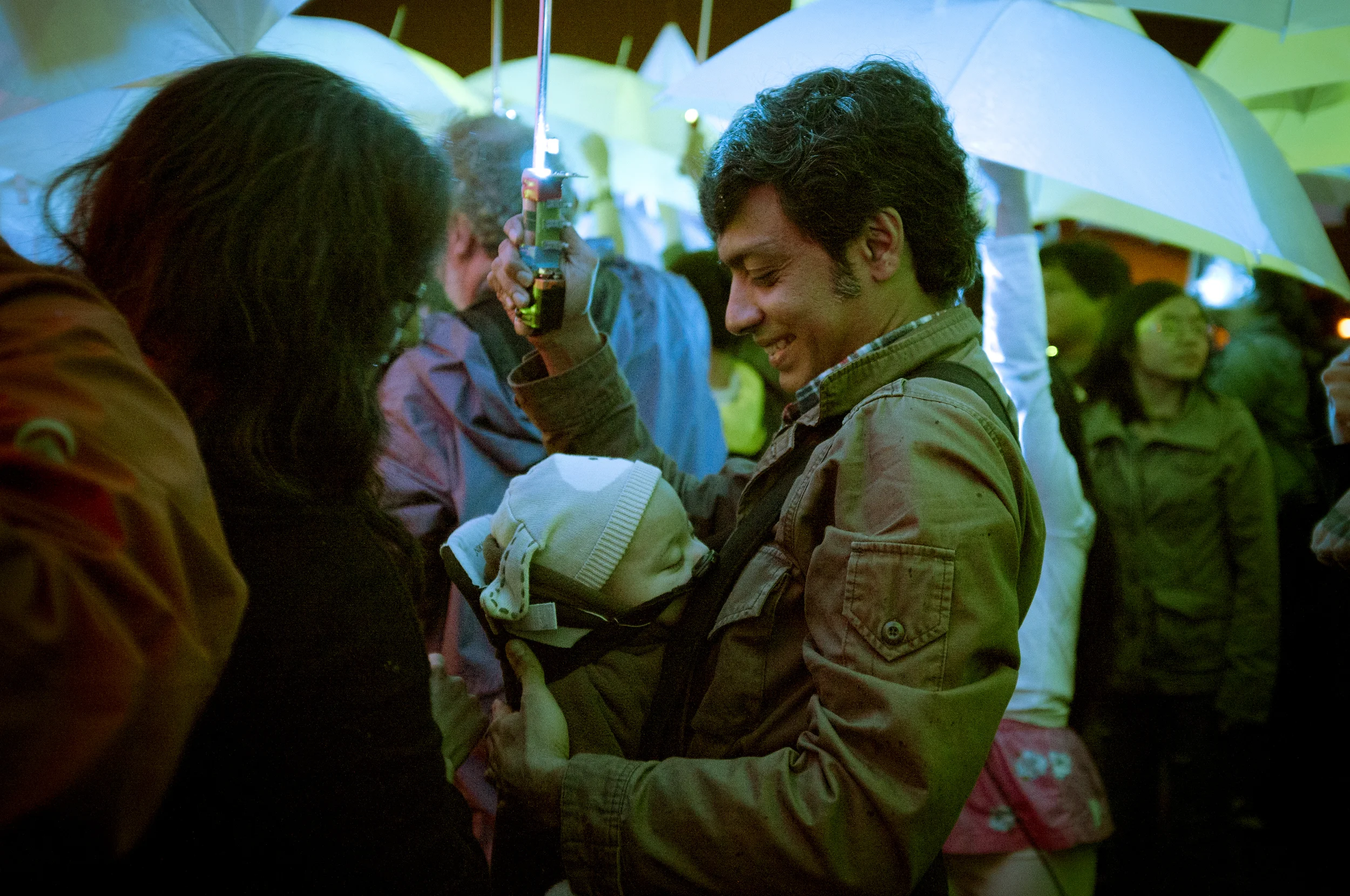  A baby falls sleeps during MIT's "UP", an interactive umbrella performance. Cambridge, MA. 2013 