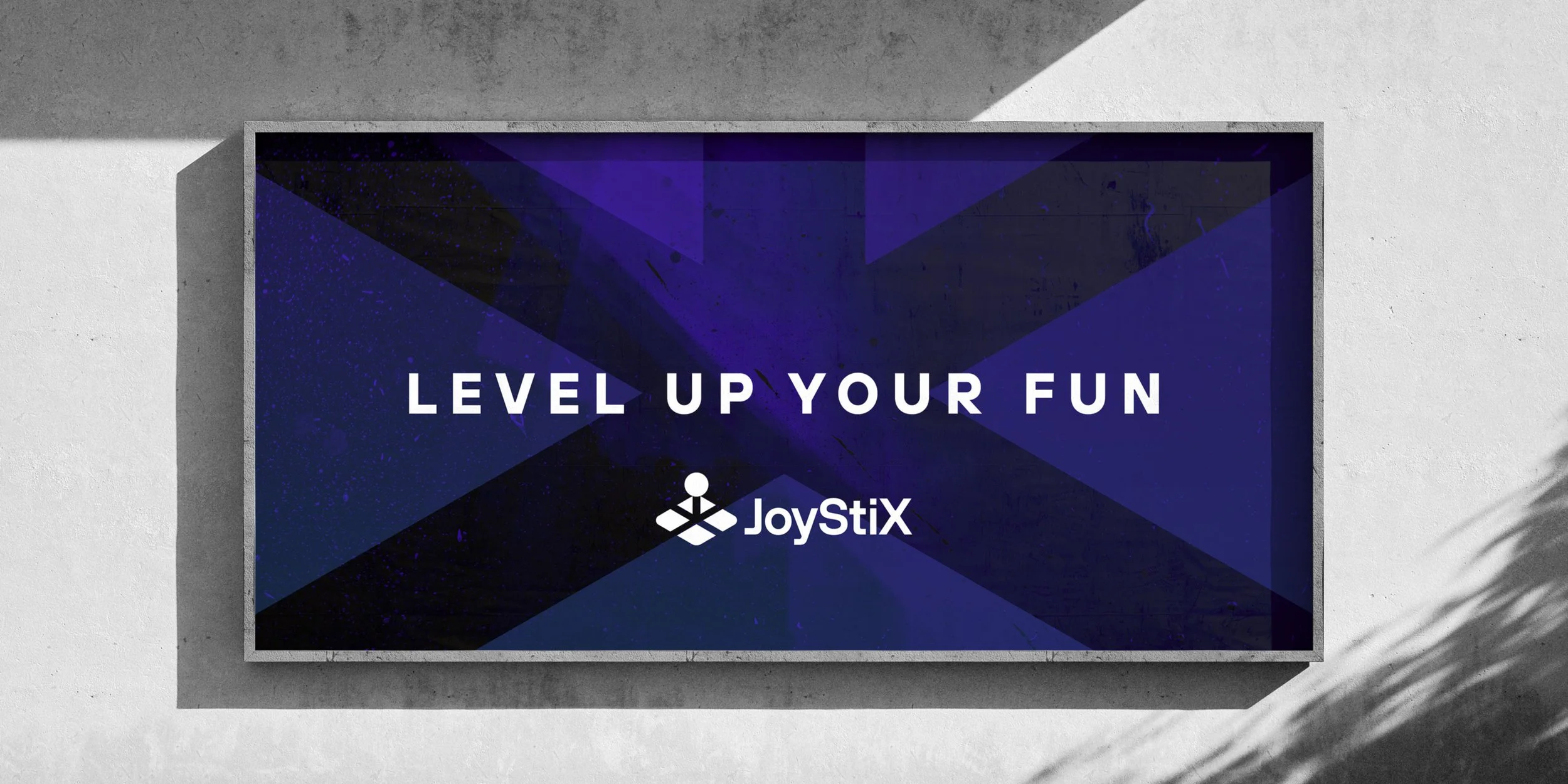 JoyStiX logo and Level Up Your Fun tagline displayed on an outdoor sign