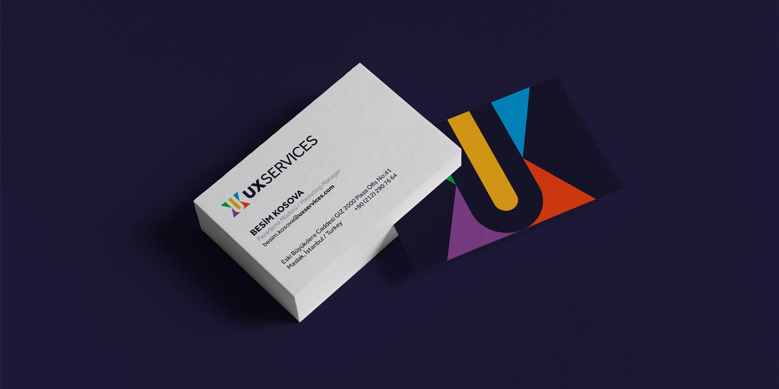 UXservices logo applied to white and dark navy business cards