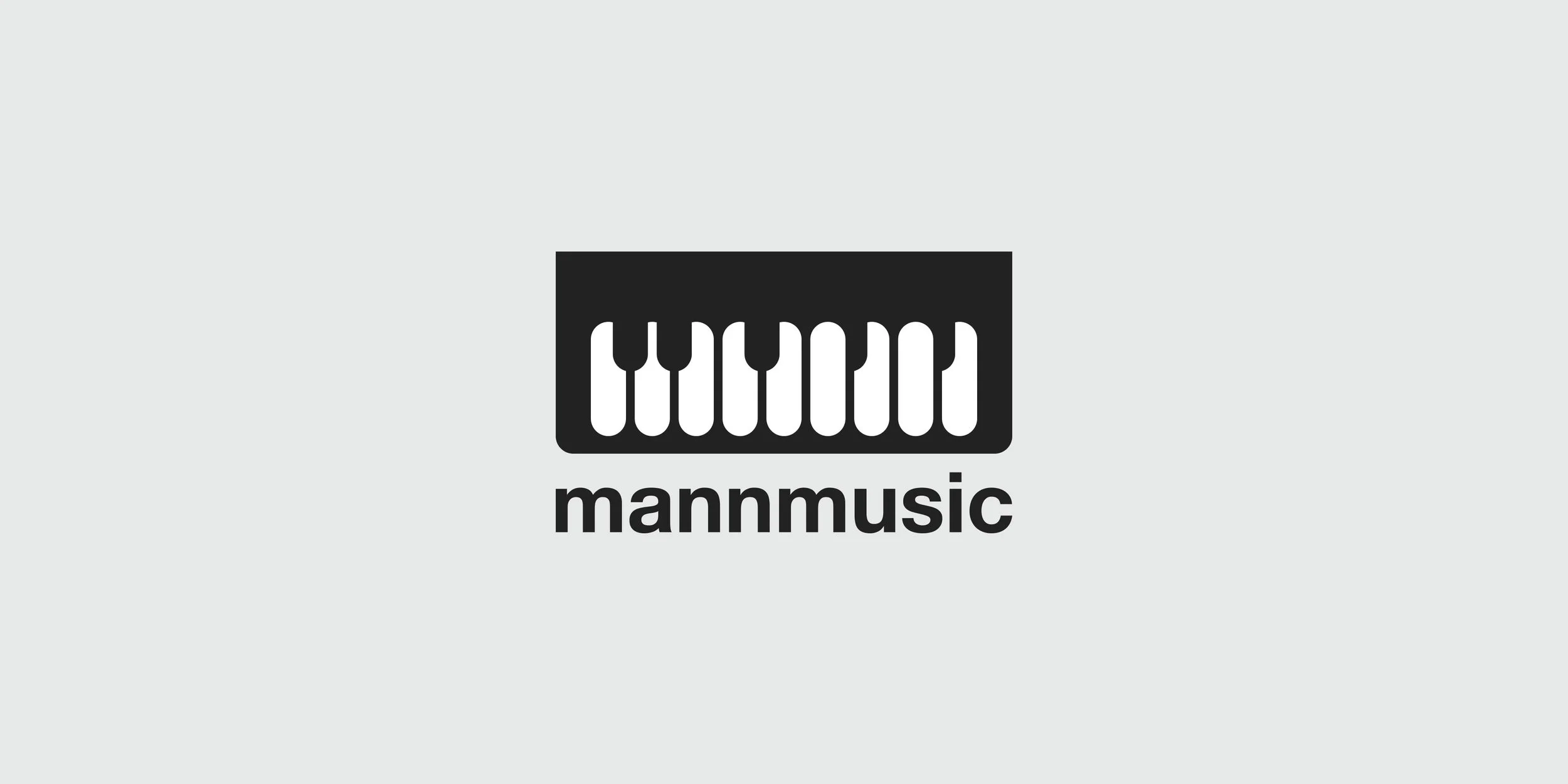 MannMusic logo design featuring a stylized piano keyboard and lowercase wordmark in black on a light gray background.