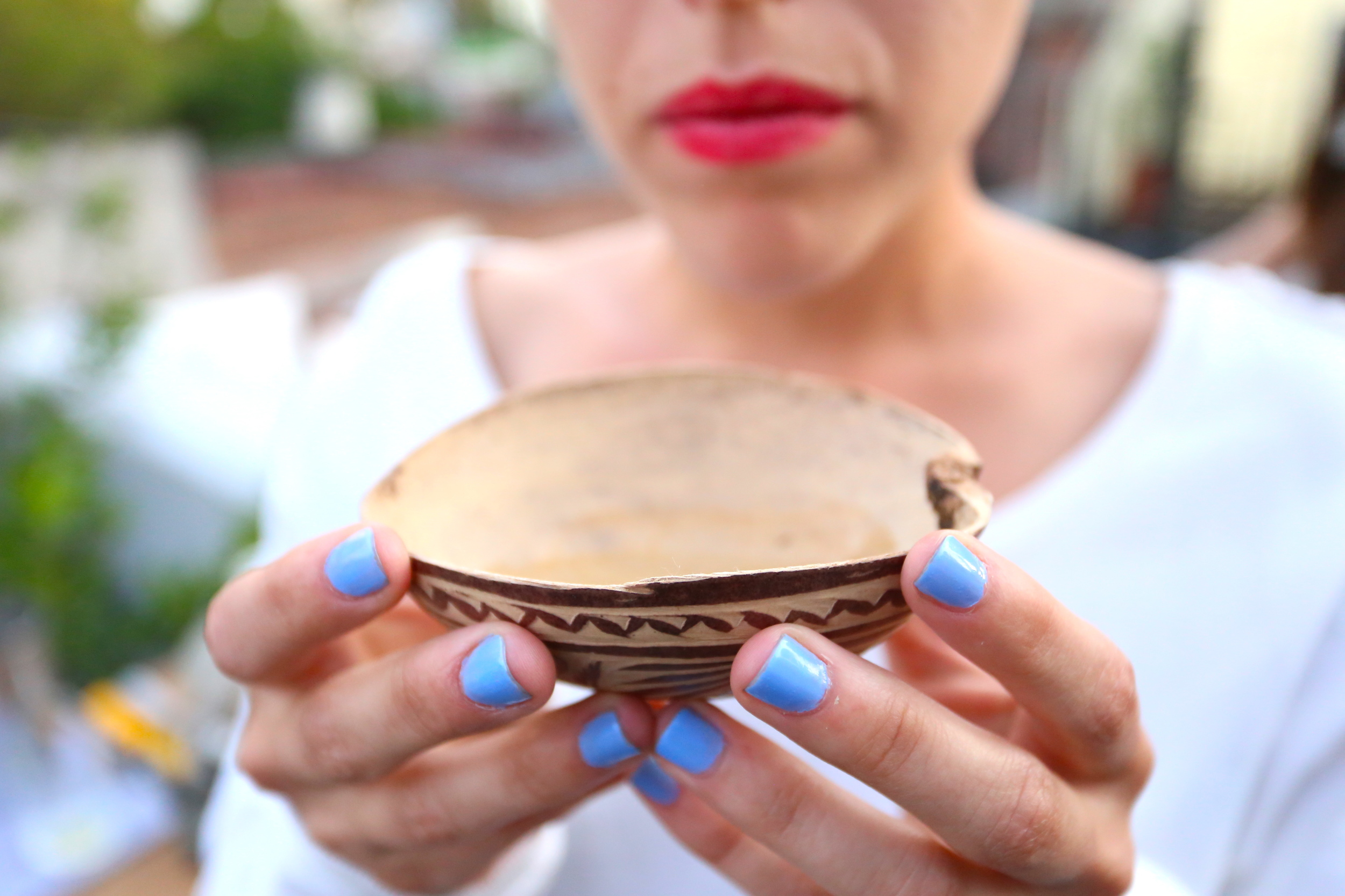 Maria demonstrating how to drink mezcal properly. 