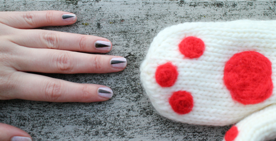 I used tape to mask off my nails to create the slivers of claw. My paws were created by needle felting little red felt patches to an existing pair of mittens.
