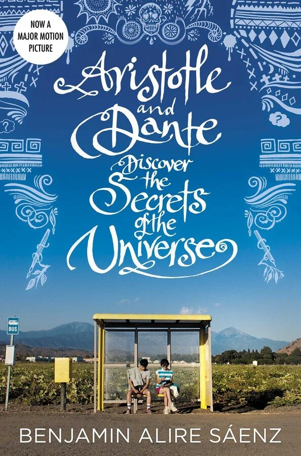 cover of Aristotle and Dante Discover the Secrets of the Universe, two boys sitting at a bus stop under blue sky