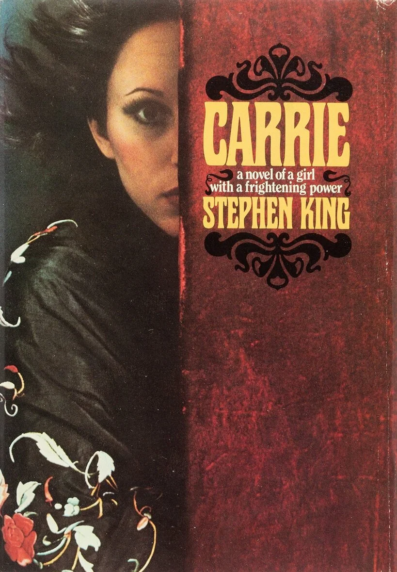 first edition of Carrie by Stephen king, girl with dark hair and eyes looking at camera on left, words on right "Carrie A Novel of a girl with a frightening power Stephen King"