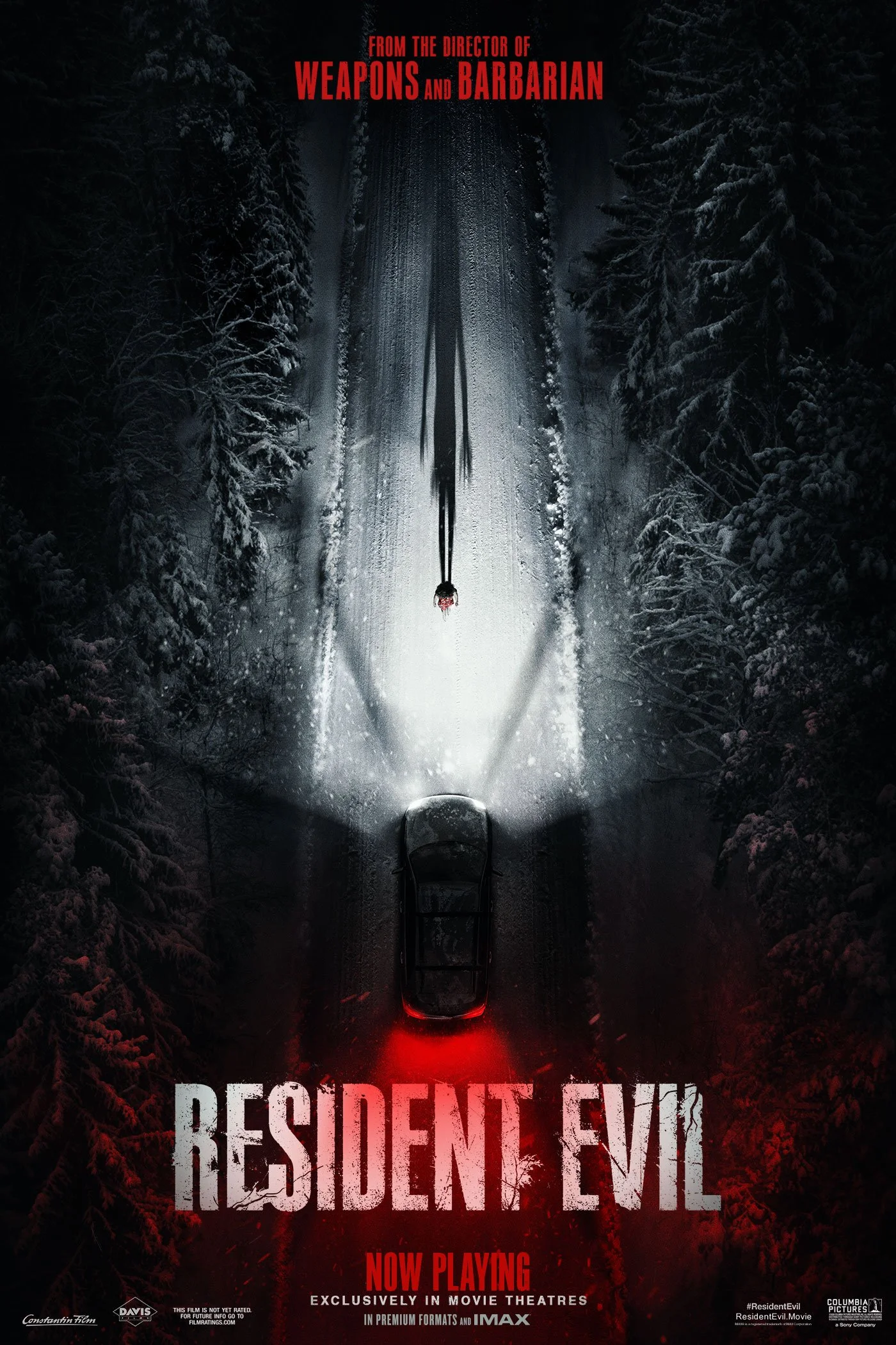 movie poster for Resident Evil (2026) an over head shot showing a man standing in front of a car in the snow