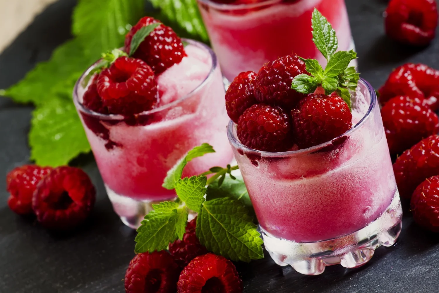 Raspberry granita with berries and mint in glass cups, selective focus.jpg