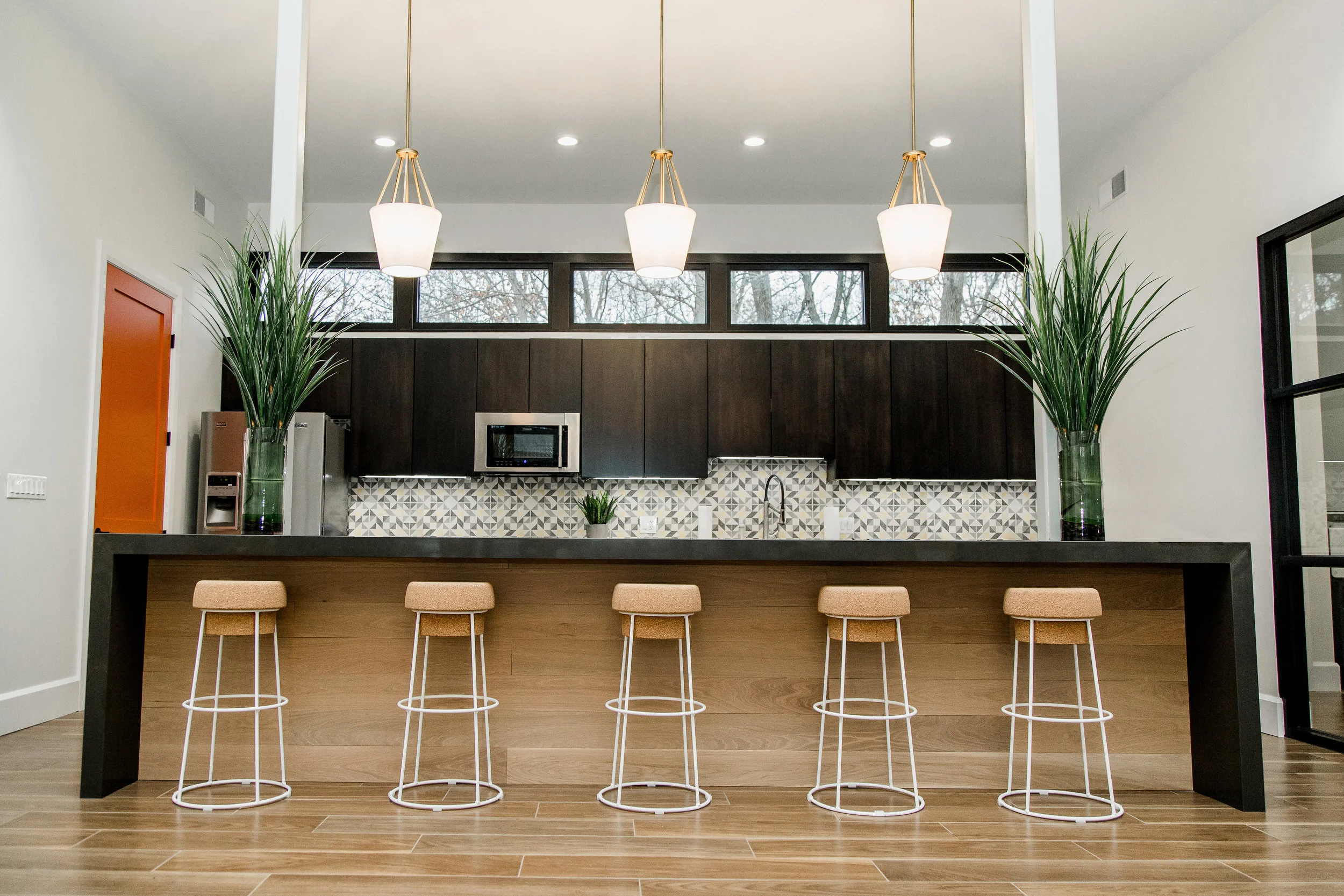 A note from the designer: These stools were so fun to select. They were designed by Orlandini & Radice , for Dom Italia. They're named the "Bouchon Counterstool". They look quite like a champagne cork and for a kitchen countertop in a shared space, what could be more fun than that? A festive stools like these were ideal for the mid-century inspired look we were going for.