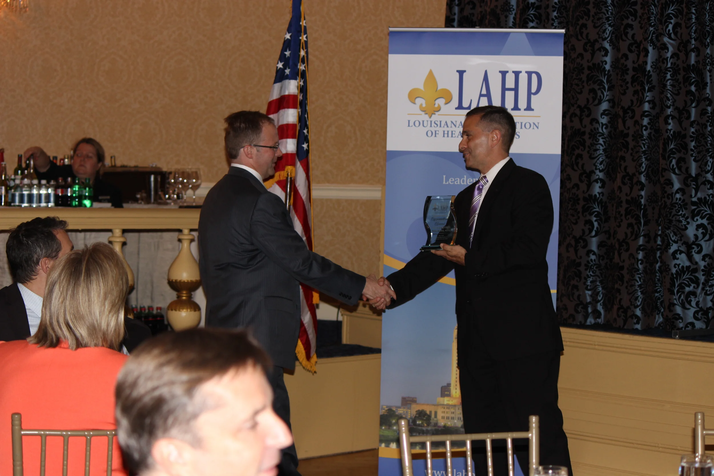  LAHP CEO Jeff Drozda (right) presents Milam Ford of Blue Cross and Blue Shield (left) with an award recognizing his service to the association's Membership Committee. 