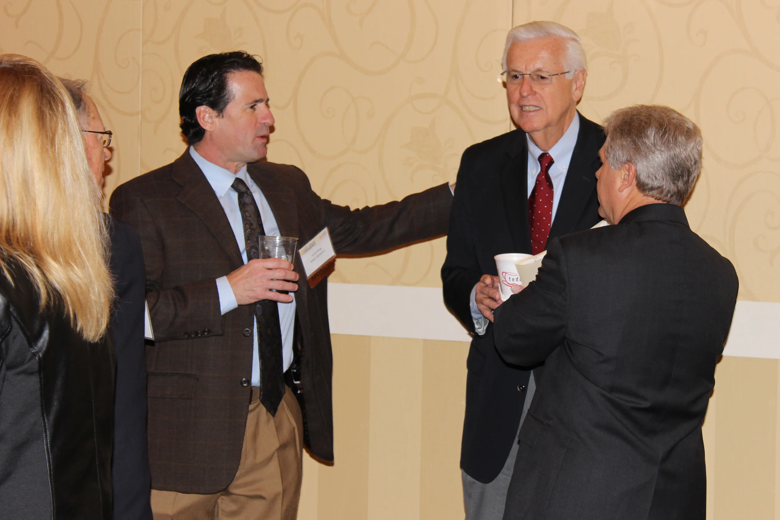  Louisiana Insurance Commissioner Jim Donelon (center) talks with Errol King of Baker Donelon (left) and Greg Cromer of the Louisiana Health Cooperative (right) 