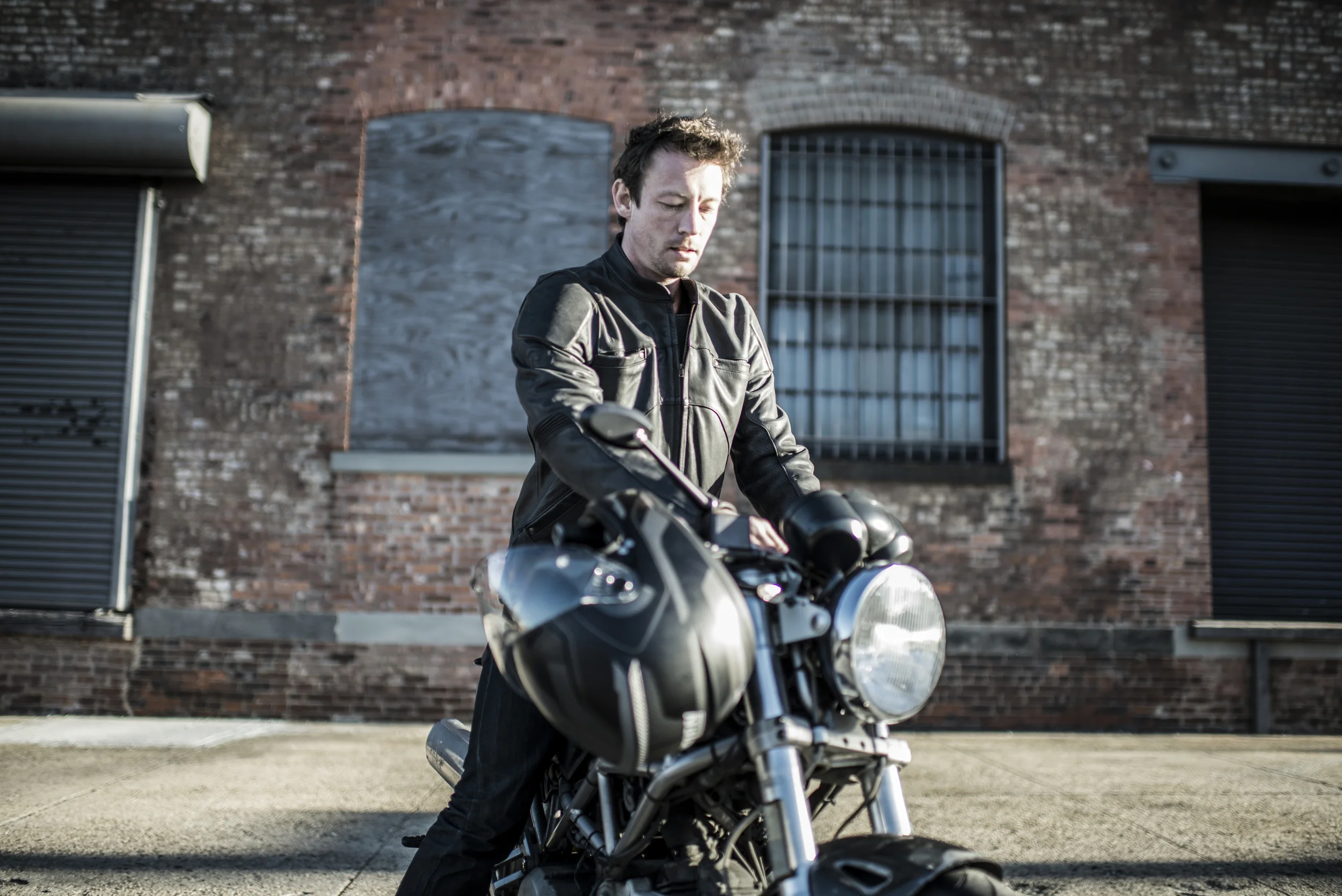 Robert on bike brick wall.jpg