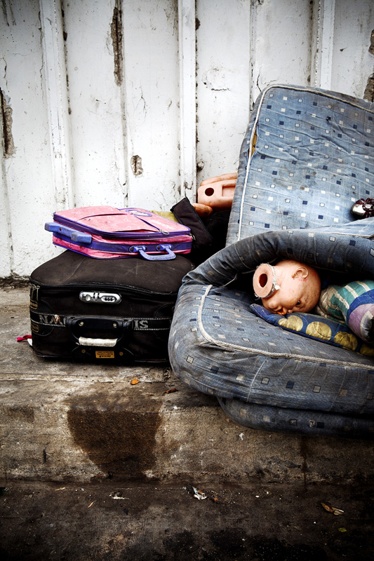 Someone's possessions and living space in a back alley next to polluted canal connected to restricted landfill. Barranquilla, Colombia 2014