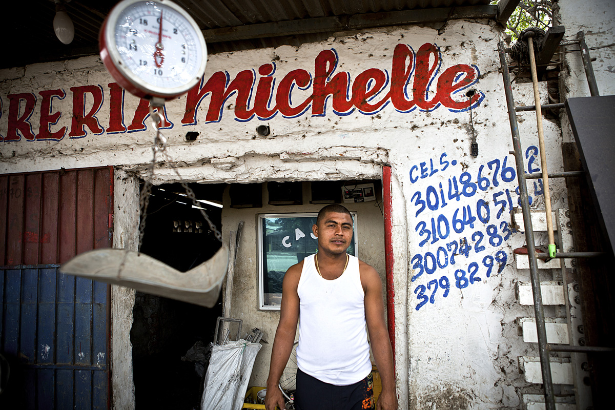 Jimmie owns a business where the local recyclers weigh and sell materials. Barranquilla, Colombia 2014