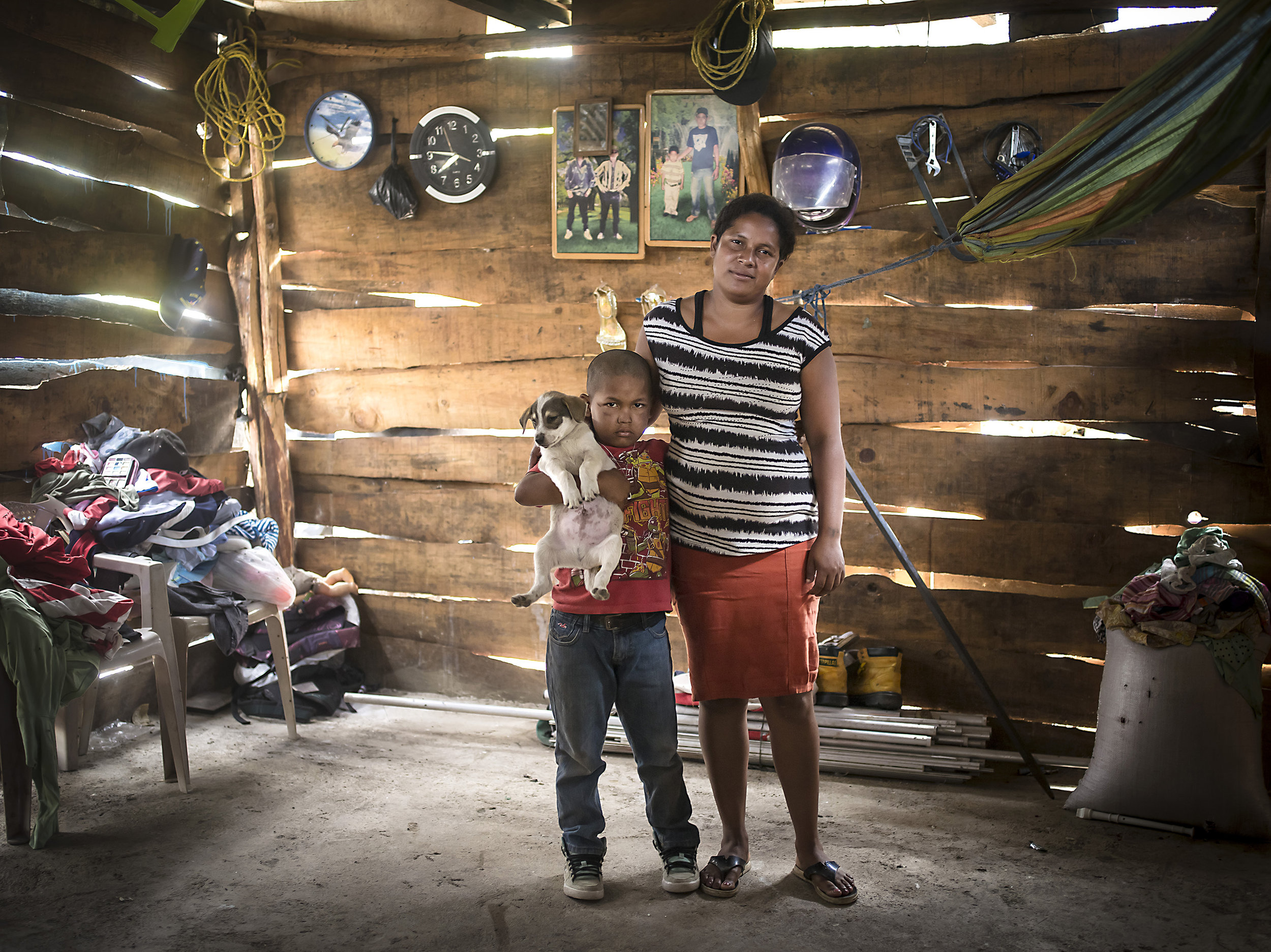 Elizabeth and her son together in their home outside the Esteli dump where they both informally sort garbage. 
