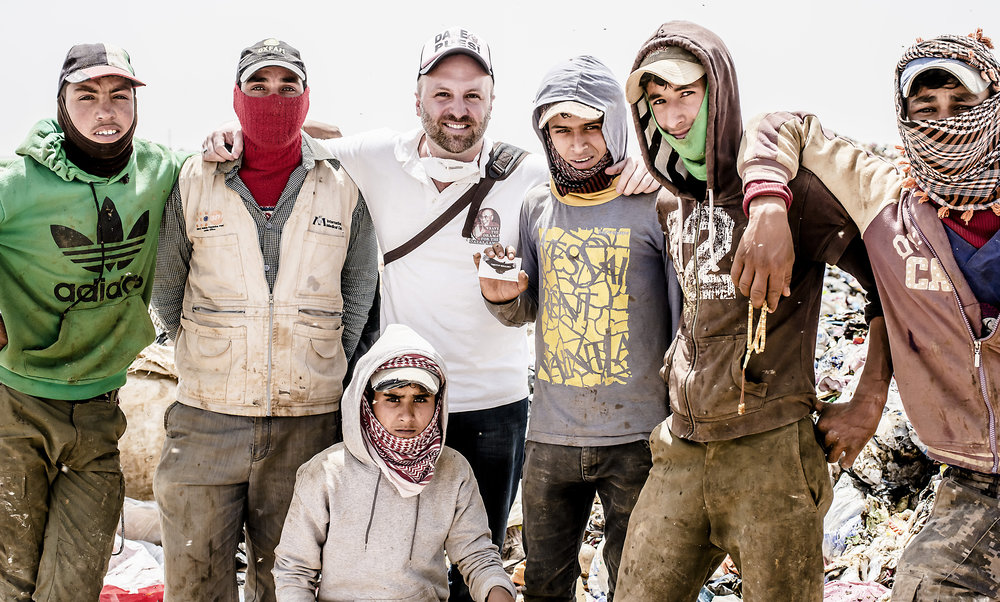 Timothy Bouldry with Syrians working at the Huseyneya dumpsite in Mafraq, Jordon. 