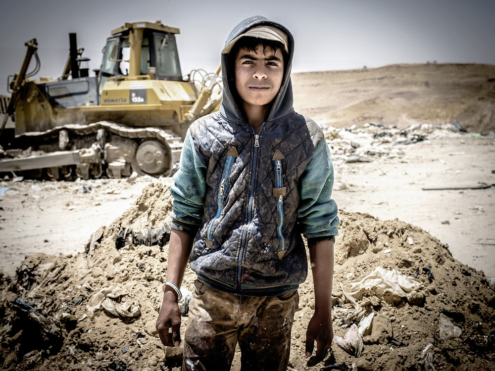 Jihad is 15 years old and stopped going to school to accompany his father to live and work at the dump 15 days at a time. 