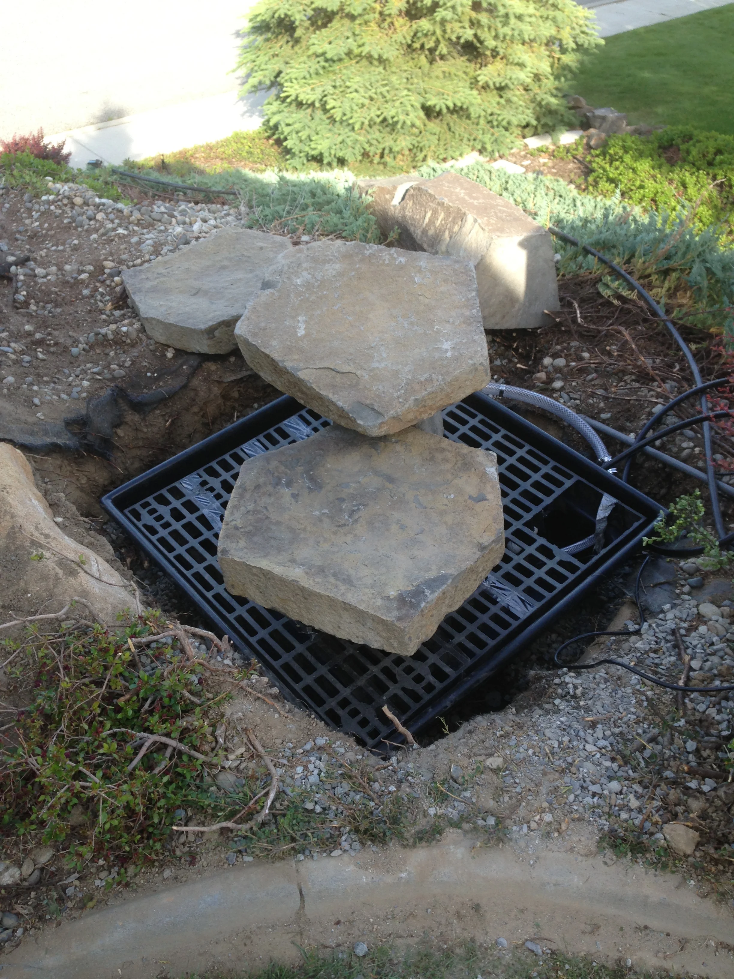 We used this 36" basin to catch the water.  Way easier than messing with pond liner.