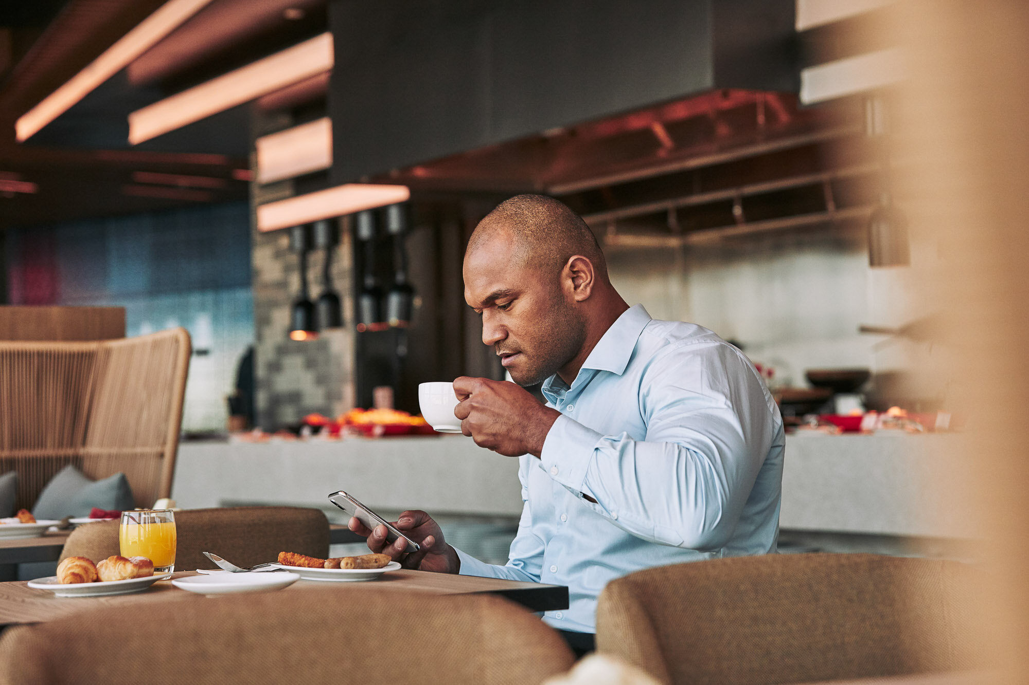 World-of-Hyatt-Business-Traveler-Man-Coffee-Mobile-Phone.jpg