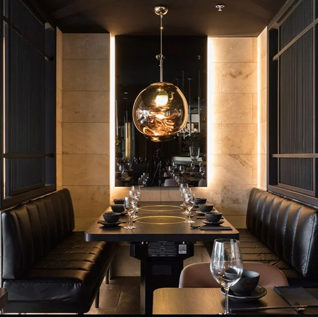 Smokin&rsquo; hot Japanese BBQ recently opened in Melbourne for our chic clients.
Our design intent was slick and super cool for a steamy BBQ.
The arrival is a heavy mulberry curtain surrounding a plinth of apricot marble and mulberry timber work.
The reveal is a wet look, black patent leather booths anchored by amber Tom Dixon organic pendants.
Off to the right is a long private dining room nestled behind a screen shaped tatami in circles and rectangles.
It&rsquo;s timeless and a vision of modern elegance.
Katori, Melbourne.
Lighting with @electrolight__ pendants @tomdixonstudio photos by @rohanvenn and, design by our wonderful and dedicated team @melissacollison built by the awesome team @demroc_bg xxxx

#glamour #japaneserestaurant #melbournerestaurant #sake #japanesebbq #japanesefood #interiordesign #design #luxury #tomdixon #lightingdesign #photography #restaurantdesign #bar #champagne #sushi #bbq #marble #leather #linen