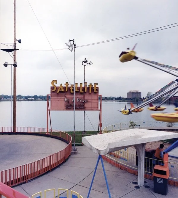 August brings to mind the whirling imagery of amusement parks- electric carnivals, sticky cotton candy under the tongue, a turbulence of colors and twinkling tunes over steaming asphalt. Once synonymous with summertime, amusement parks and carnivals 