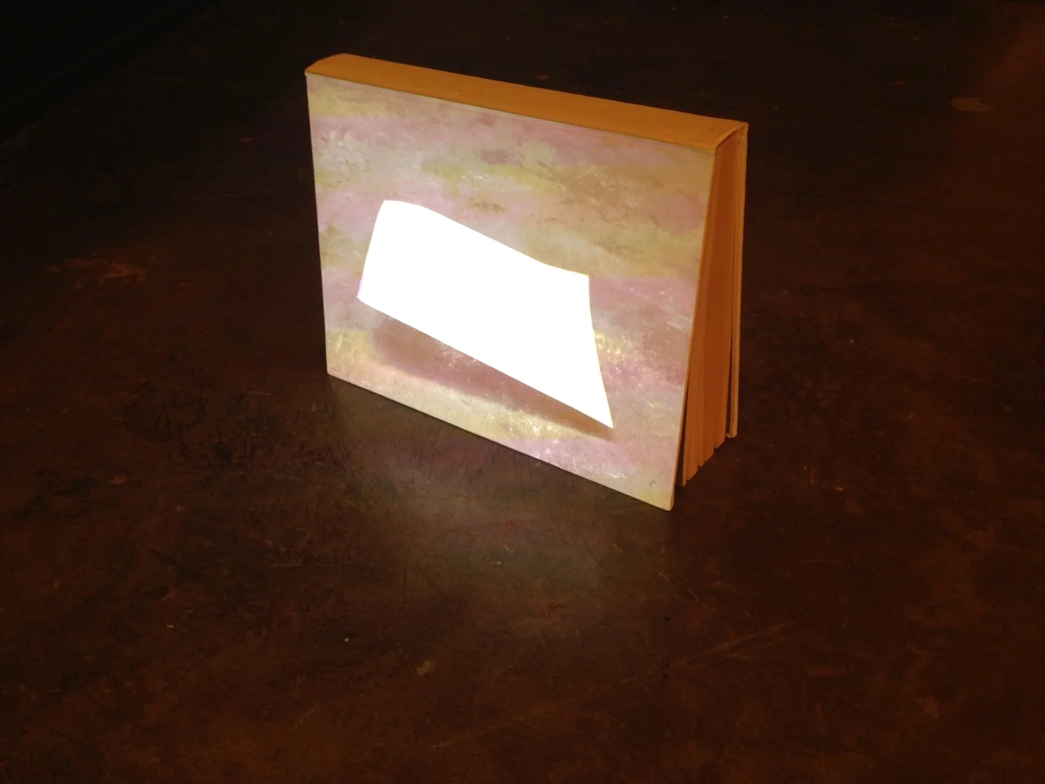 Ken Matsubara's Paper in the Wind (movie, vintage book, projector, mixed media, 2014) at MA2Gallery's booth at Art Dubai 2015.