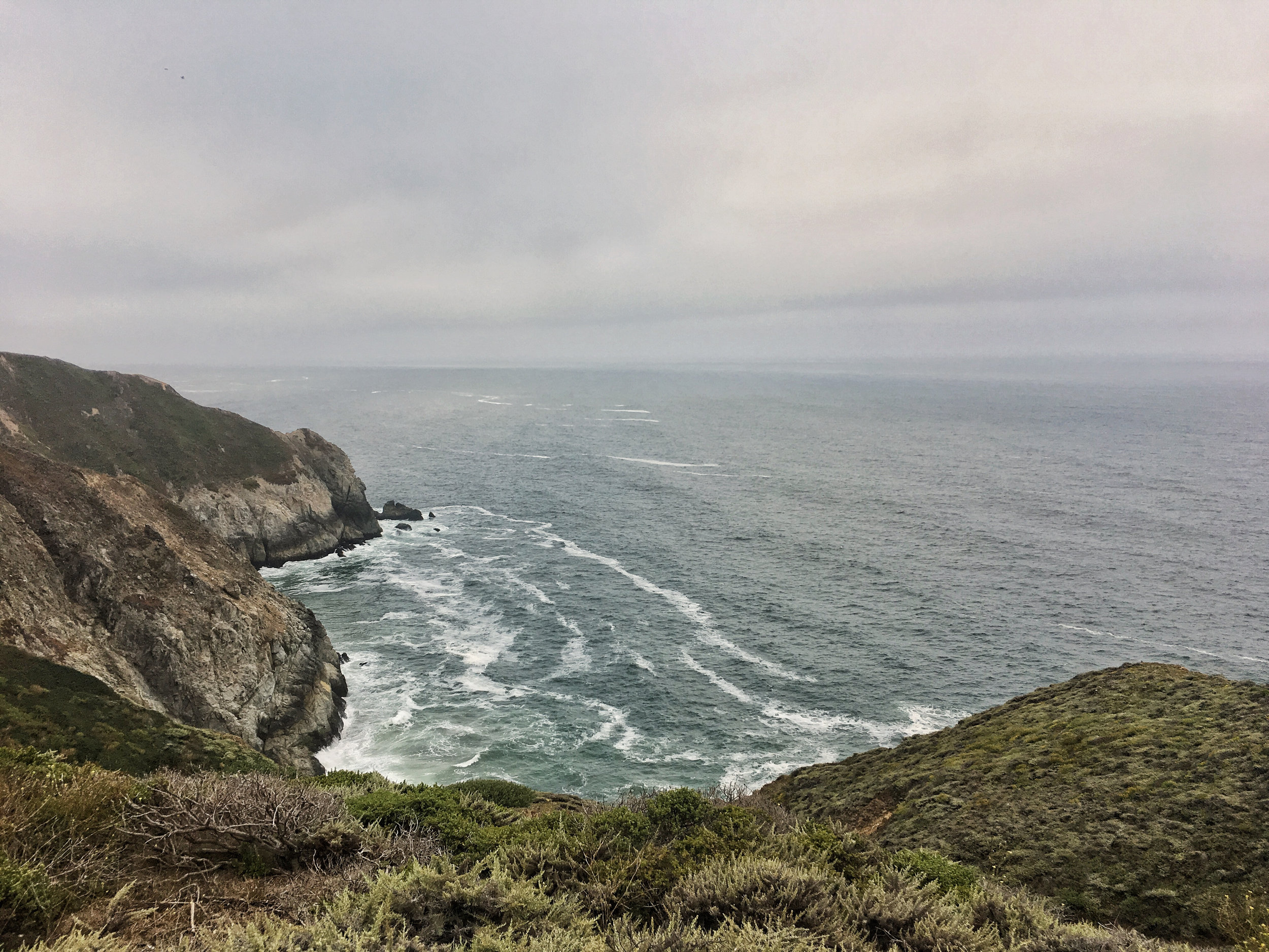 the pacific ocean washes against the coastline on a chilly morning ride. Pacifica, CA