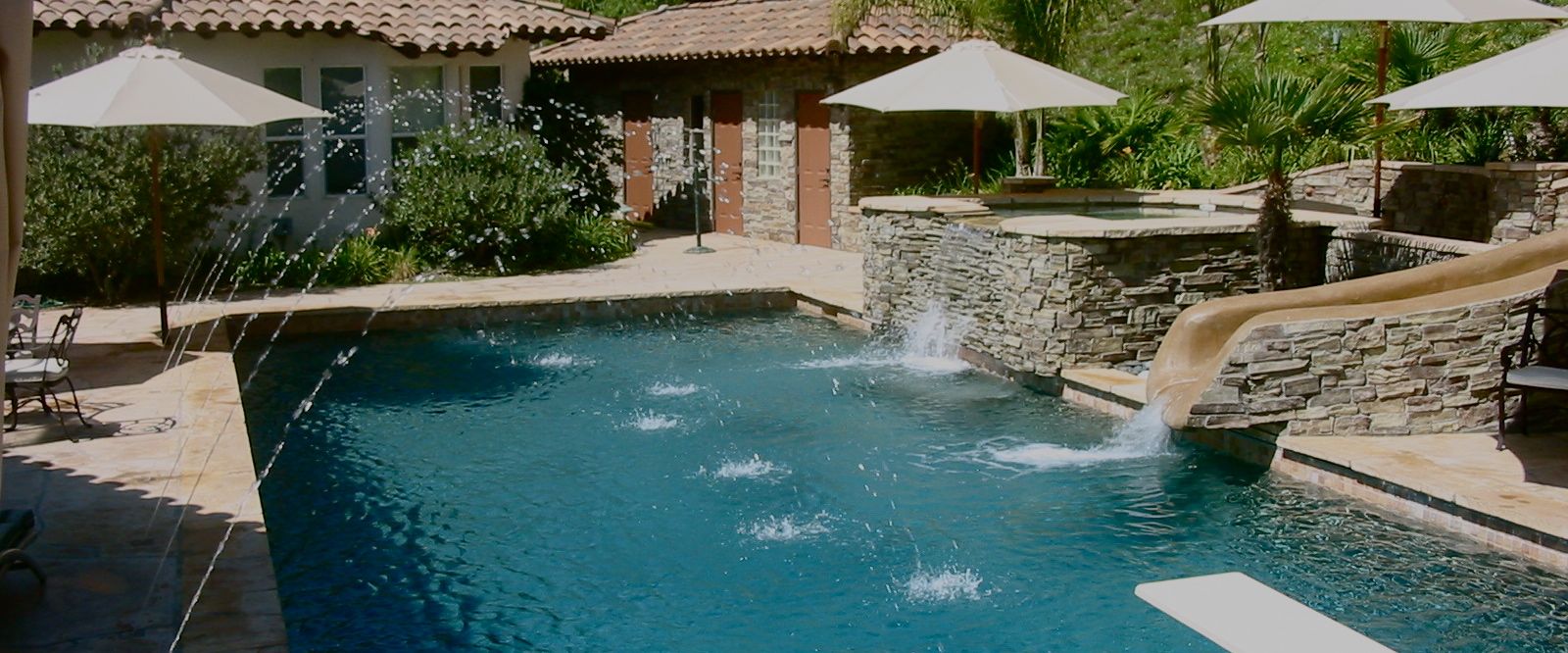Pool with spa overflow, slide and water features.jpg
